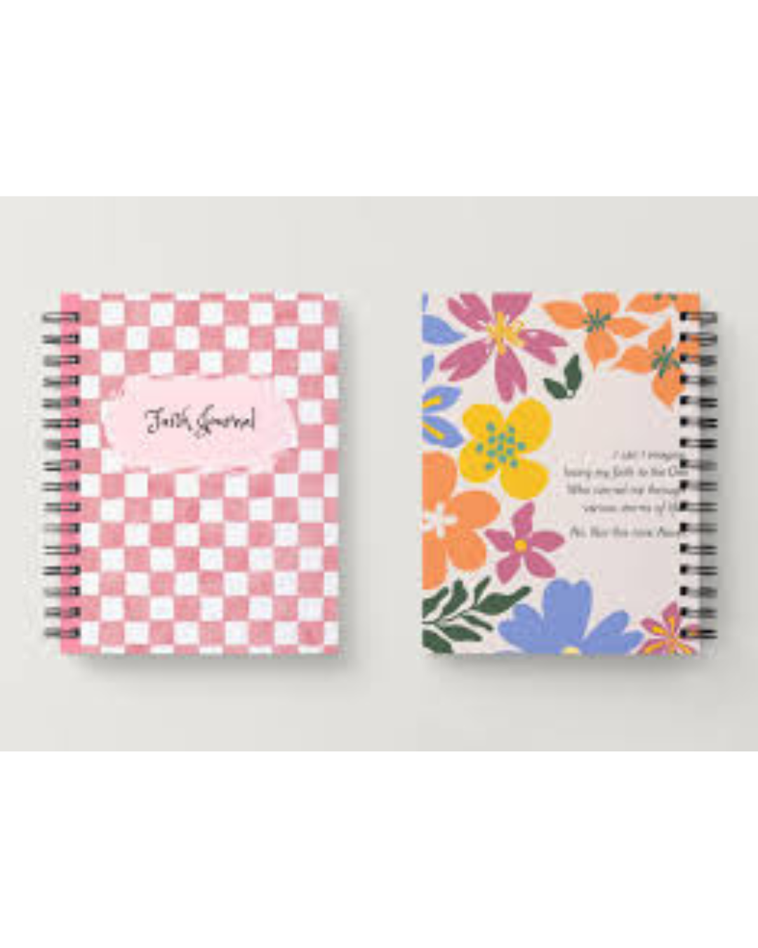 Two spiral-bound notebooks shown side by side against a light gray background. The left notebook has a pink and white checkerboard cover with a pink label reading 'Faith Journal.