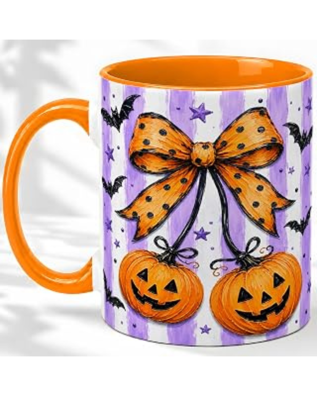 A ceramic mug with an orange handle and interior, decorated with a purple and white striped pattern, featuring a large orange polka-dot bow, two jack-o'-lanterns, and black bats.
